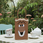 Alice in Wonderland Doorknob party favor bag displayed on a tea party table, handcrafted with layered foam details and perfect for themed birthday celebrations