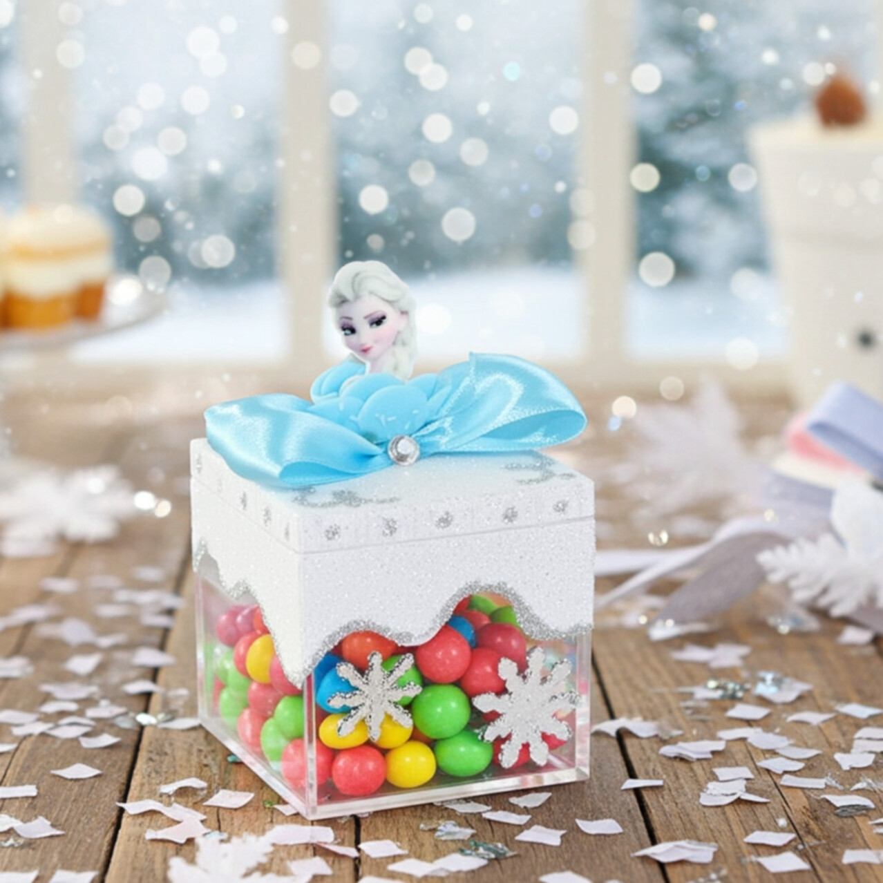 Handmade Frozen candy box decorated with Elsa figure, blue satin bow, and silver snowflakes. Filled with colorful candies for Frozen birthday celebrations.