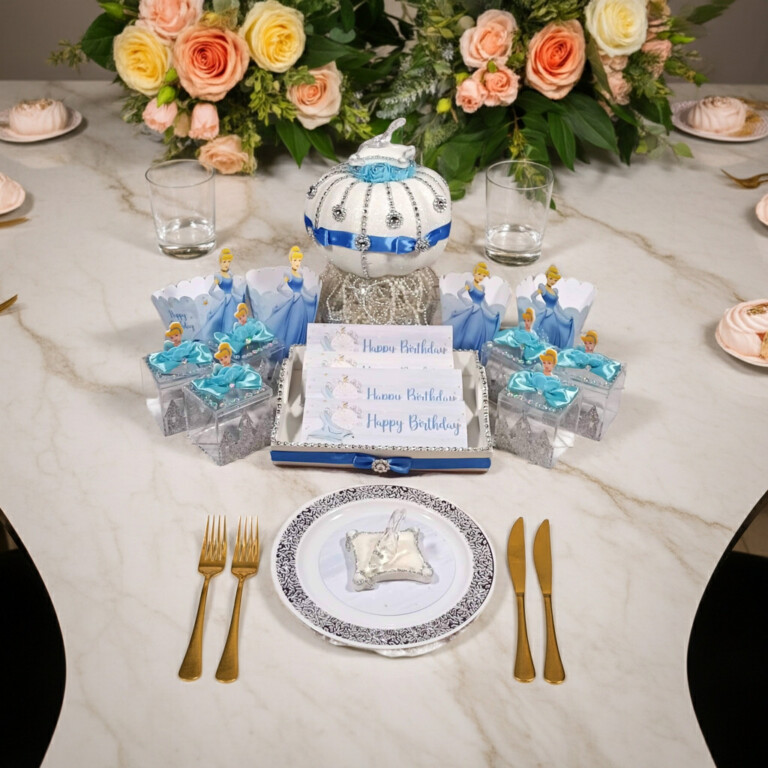 Handmade Cinderella party centerpiece Carriage Favor Box with glittered wheels and satin blue ribbons — perfect for princess birthday parties and fairy-tale celebrations by Party By Imagination.