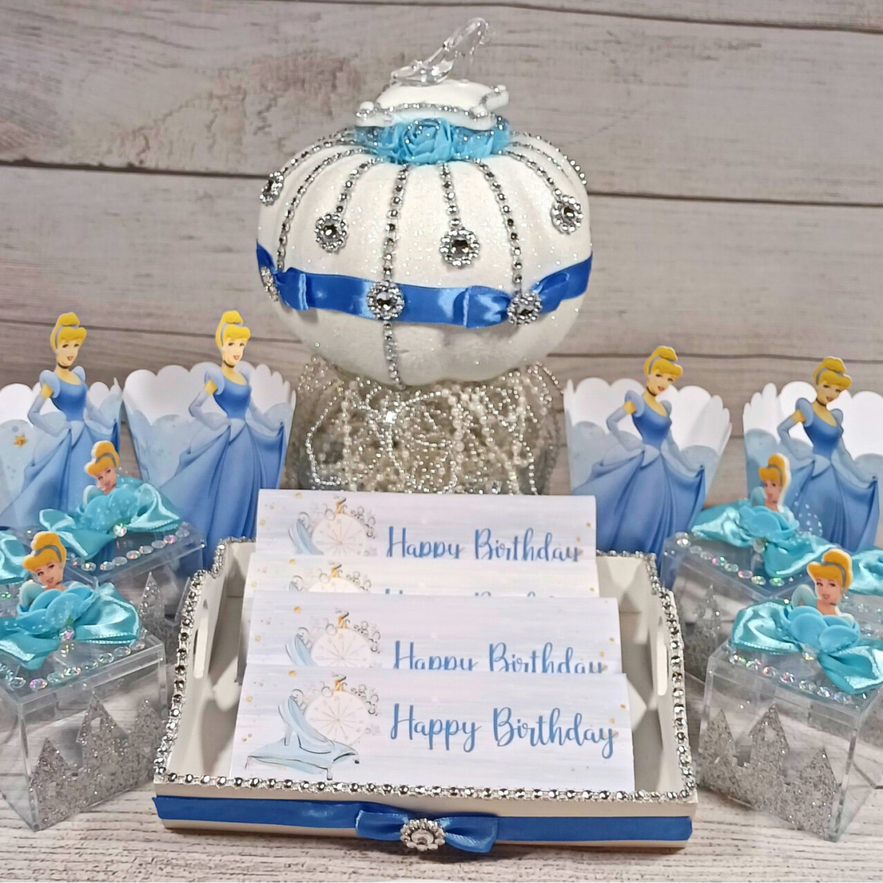 Handmade Cinderella party centerpiece Carriage Favor Box with glittered wheels and satin blue ribbons — perfect for princess birthday parties and fairy-tale celebrations by Party By Imagination.