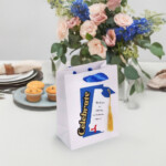 Personalized graduation gift bag with name and cap design, handmade by Party By Imagination