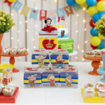 Set of 5 Snow White acrylic favor boxes with Seven Dwarfs characters displayed in a colorful birthday party setup with themed decorations.
