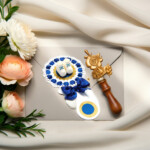 Blue baby shower rattle favor gift with baby shoes and blue ribbon flat lay