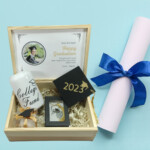 Personalized high school graduation wooden gift box with keepsake items and Class of cap inside