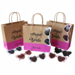 Personalized Maid of Bride gift bag with heart sunglasses for bridal party celebrations, bridal shower favors, bridesmaid gifts, wedding welcome bags, and bachelorette party accessories. Handmade bridal party bag with custom name personalization and trendy heart-shaped sunglasses in pink, white, black, and nude colors.